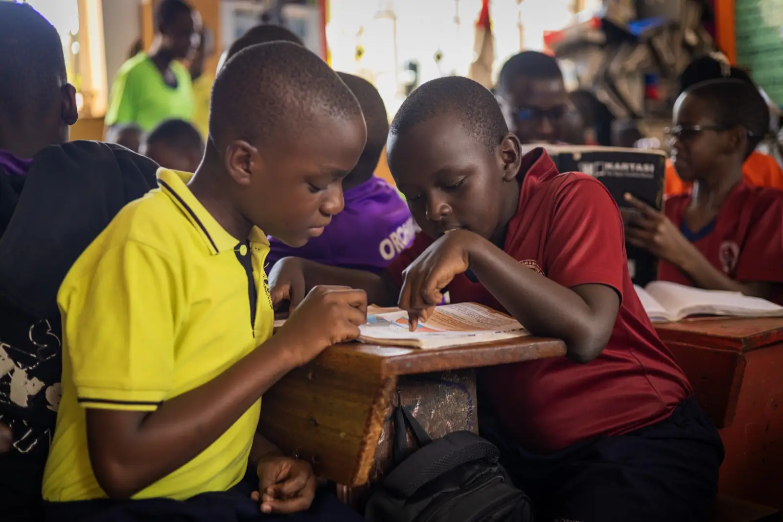 Two learners reading together in class
